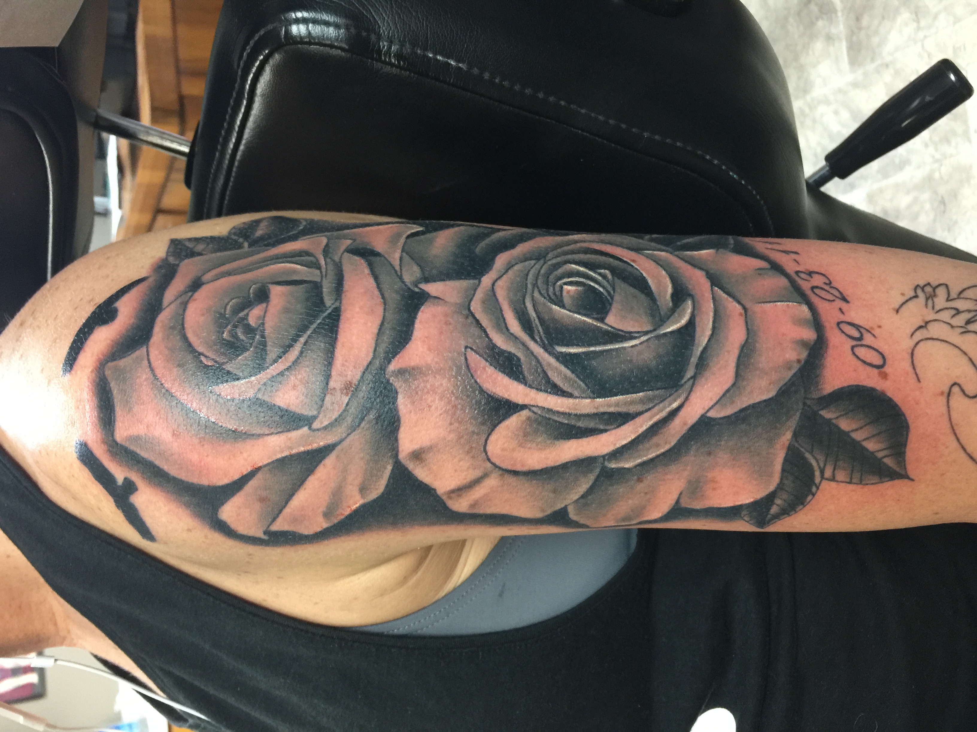 Black and grey rose arm tattoo